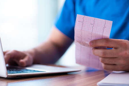 Young male doctor cardiologist working in the clinicの写真素材