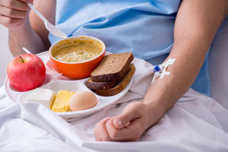 The male patient eating food in the hospitalの写真素材