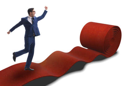 Businessman on red carpet isolated white backgroundの写真素材