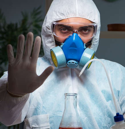 Young make scientist working with dangerous hazardous substances