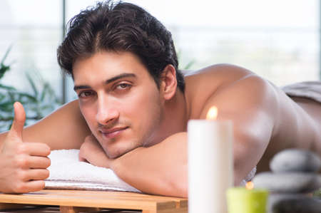 Young handsome man during spa procedureの写真素材