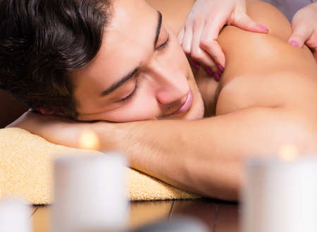 Young handsome man during spa procedureの写真素材