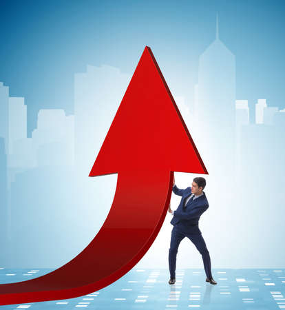 Businessman supporting growtn in economy on chart graphの写真素材