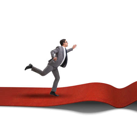 Businessman on red carpet isolated white backgroundの写真素材