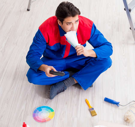 Young painter trying to match colours for painting jobの写真素材