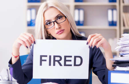 Businesswoman with message in office at deskの写真素材
