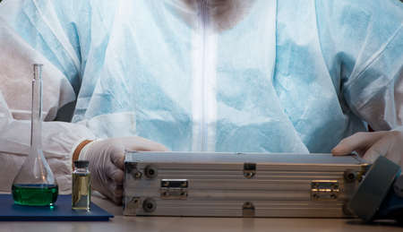 Forensic investigator working in lab looking for evidenceの写真素材