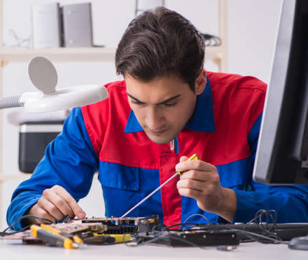 Professional repairman repairing computer in workshop