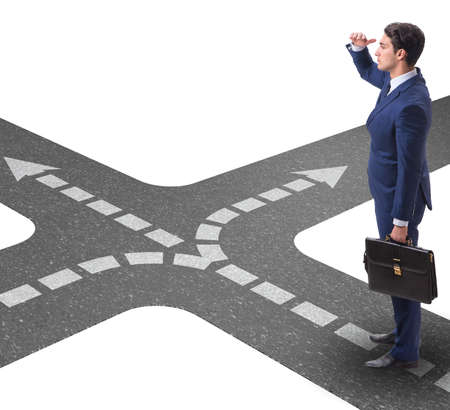 Young businessman at crossroads in uncertainty conceptの写真素材