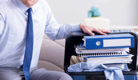 Businessman preparing packing for business tripの写真素材