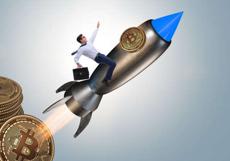 Businessman flying on rocket in bitcoin price rising conceptの写真素材