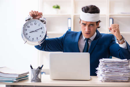 Head injured male employee working in the officeの写真素材