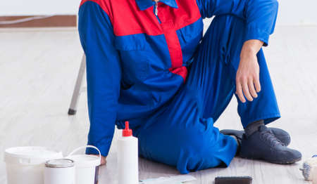 Young painter trying to match colours for painting jobの写真素材