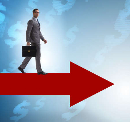 Businessman with dollar walking on arrow sign