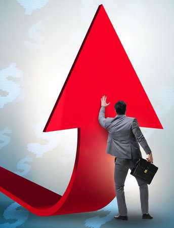 Businessman supporting growtn in economy on chart graphの写真素材