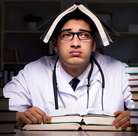 Medical student preparing for university exams at nightの写真素材