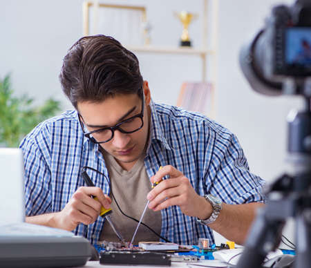 Vlogger recording computer repair on camera for vlog blogの写真素材