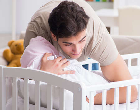 Young father dad frustrated at crying babyの写真素材
