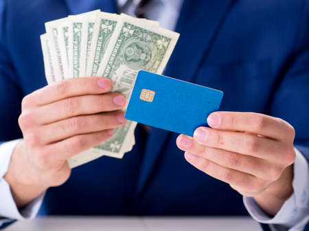 Businessman holding dollar money and credit card