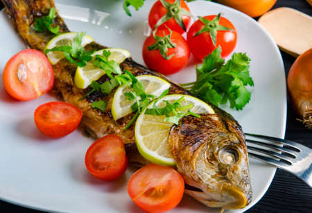 The fried fish served on the plateの写真素材