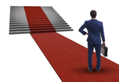 Young businessman climbing stairs and red carpet on white backgrの写真素材