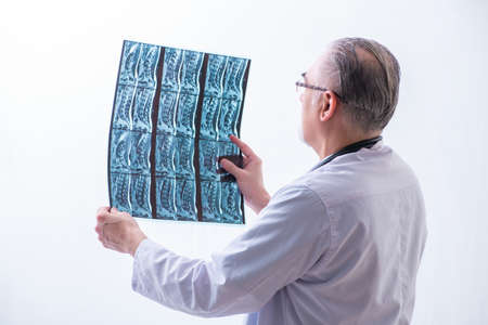 Old male doctor working in the clinicの写真素材