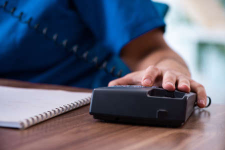 Young male doctor in telehealth conceptの写真素材