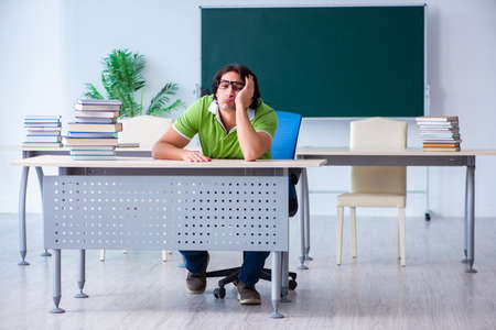 Young male student in front of green boardの写真素材