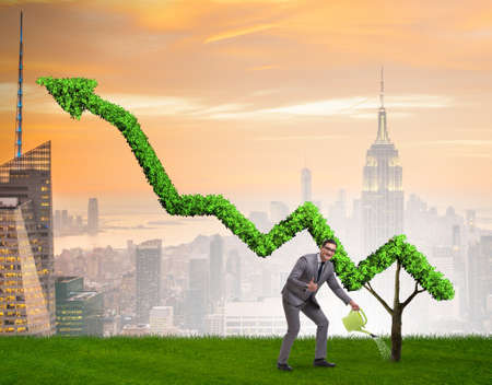Businessman in investment concept watering financial line chartの写真素材