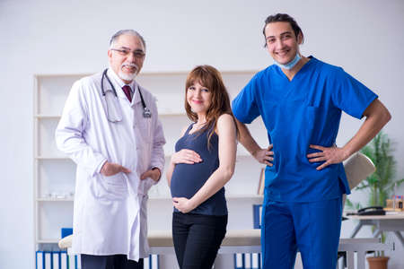 Two doctors examining young womanの写真素材
