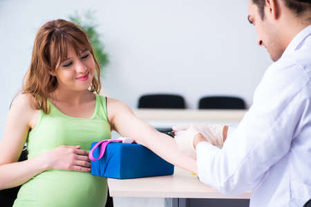 Young pregnant woman in blood transfusion conceptの写真素材