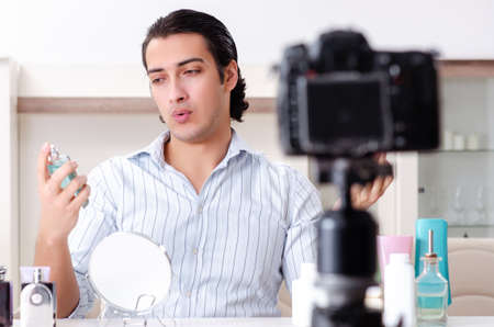 Young handsome man recording his blog in hygiene conceptの写真素材