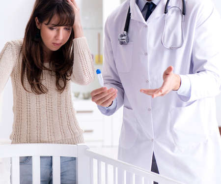 Doctor explaining to young motherの写真素材