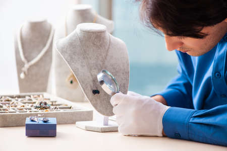 Young jeweler working in his workshopの写真素材