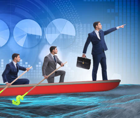 Team of businessmen in teamwork concept with boatの写真素材