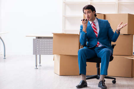 Young handsome businessman moving to new workplaceの写真素材
