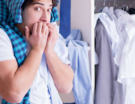 Man helpless with dirty clothing after separating from wifeの写真素材
