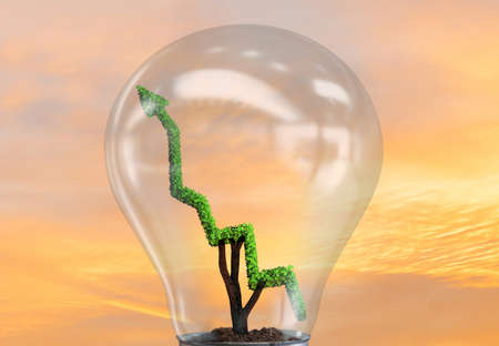 Green energy concept with green line graph in light bulbの写真素材