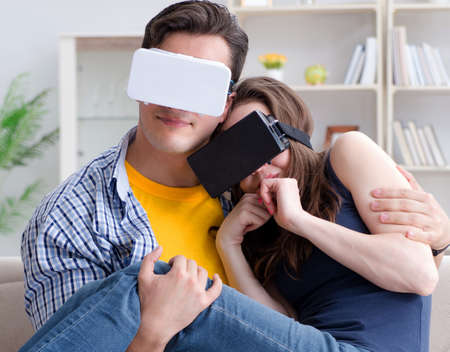 Young family playing games with virtual reality glassesの写真素材