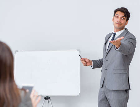 Business presentation in the office with man and womanの写真素材