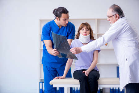 Two doctors examining young womanの写真素材