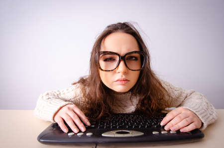 Funny nerd girl working on computerの写真素材