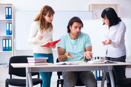Old teacher and students in the classroomの写真素材