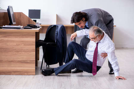 Male employee suffering from heart attack in the officeの写真素材