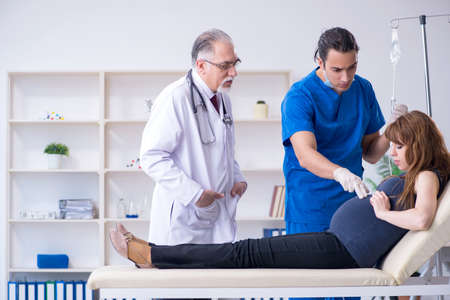 Two doctors examining young woman