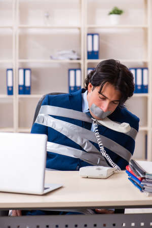 Young tied male employee in the officeの写真素材