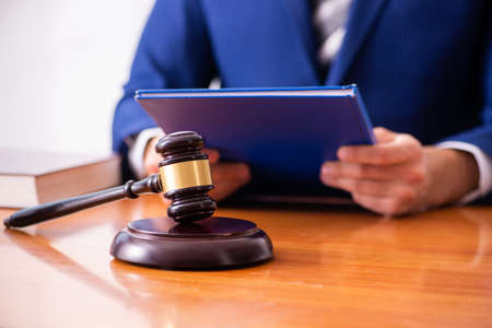 The young male judge sitting in courtroom