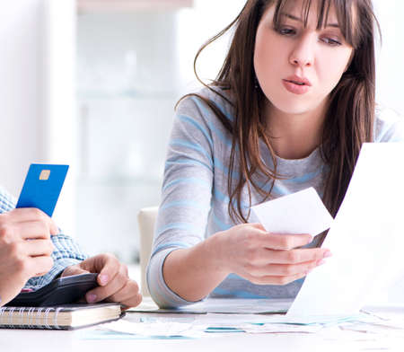 Young couple looking at family finance papers