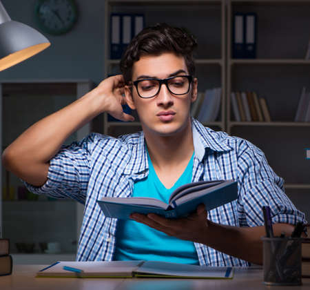Student preparing for exams late night at homeの写真素材