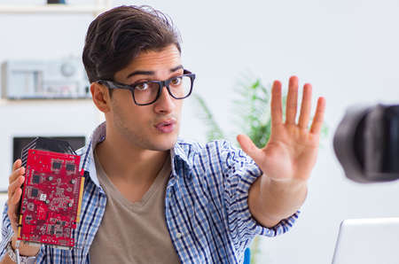 Blogger recording computer repair on camera for  blogの写真素材